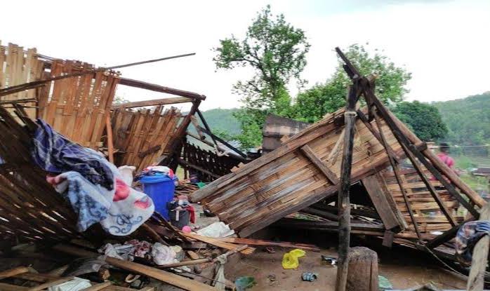 Collapsed wooden structure and debris after severe rain and storm damage in Mizoram.