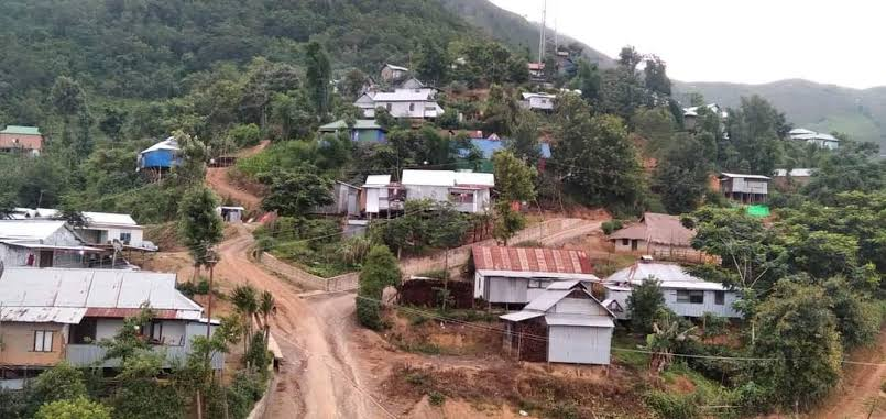 Hilly village landscape in Ukhrul district with scattered houses and roads.
