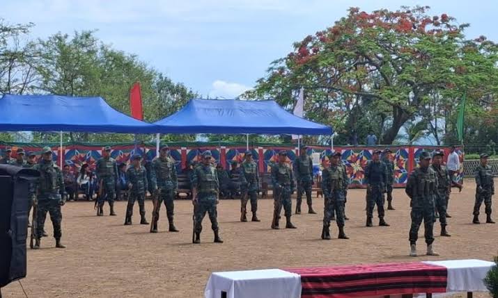 Uniformed personnel standing in formation at a ceremony in Mizoram marking insurgency surrender.