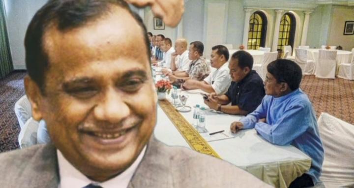 Meeting scene with officials seated at a table alongside a portrait image representing political discussions.