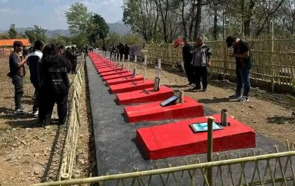 Memorial site with red graves where people gather to pay tribute.