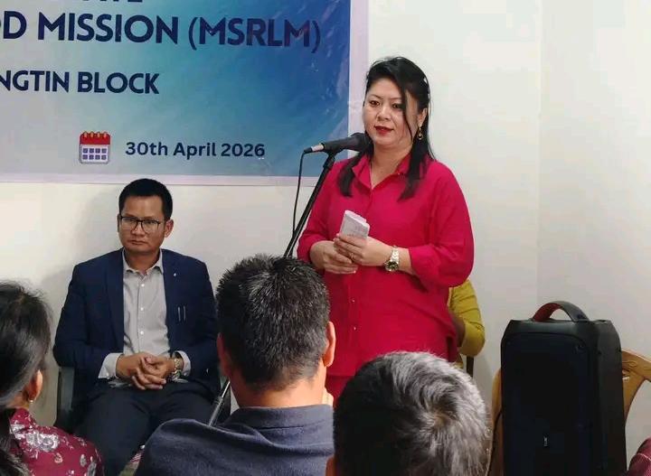 Speaker addressing a gathering at an event for rural livelihood mission launch.