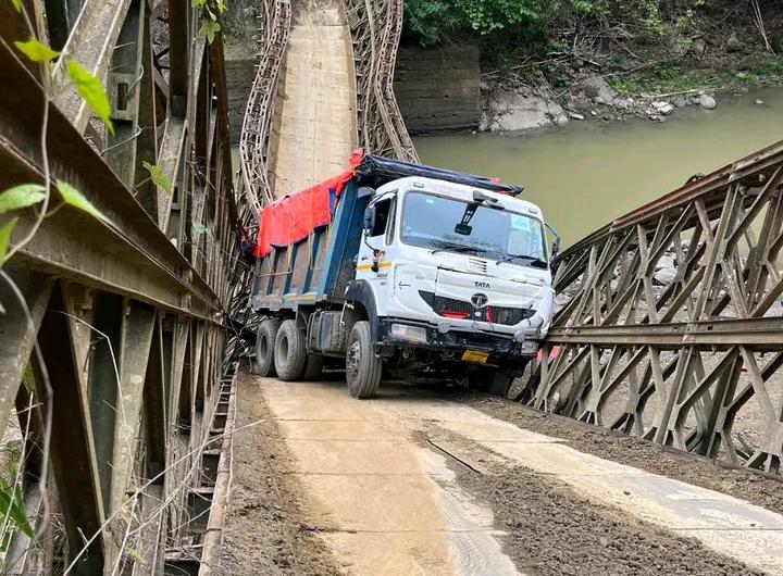 truck stuck on damaged Bailey bridge over river after partial collapse