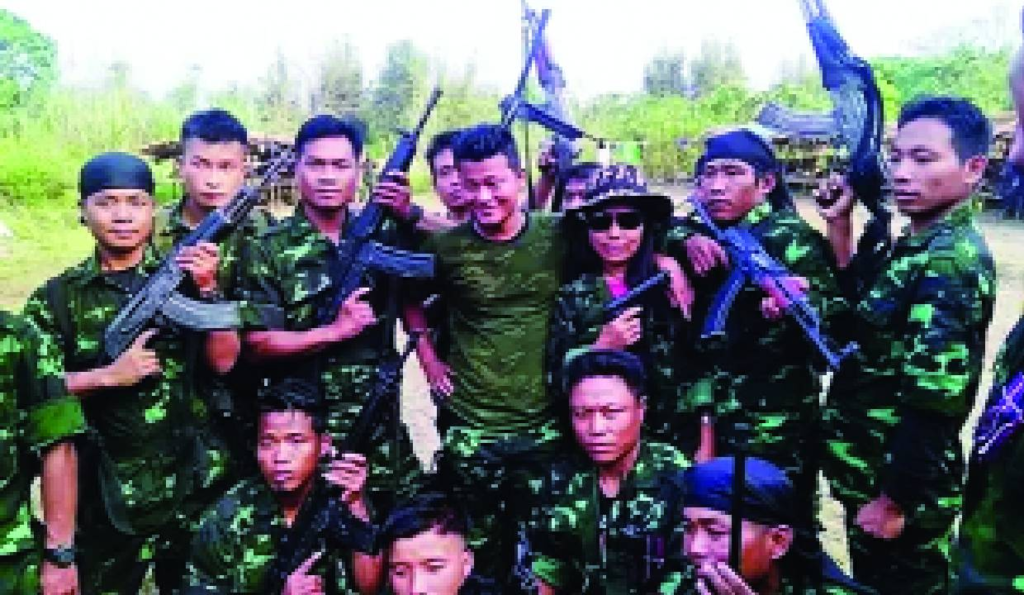 Group of armed individuals posing together before surrender under a peace agreement.
