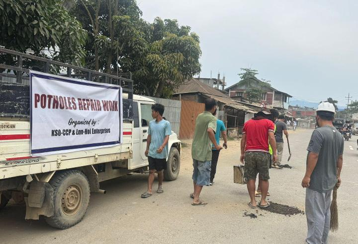 Community volunteers carrying out pothole repair work on the Tuibong Koite road