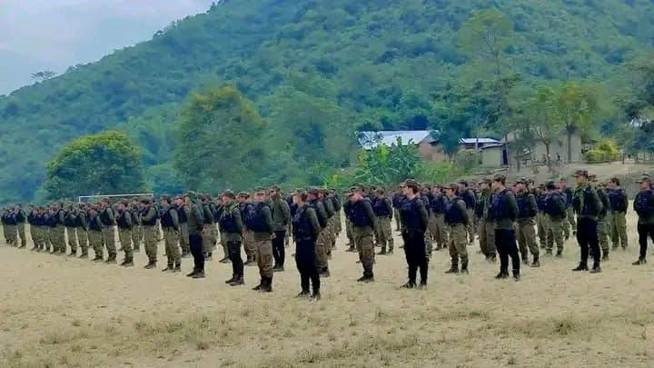 Kuki Village Volunteer members standing in formation during public gathering